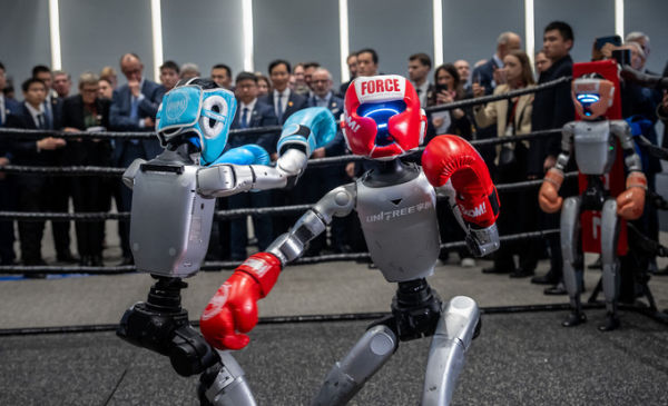 Two robot boxes while German Chancellor Friedrich Merz visits the company Unitree Robotics in Zhejiang Province and is given a tour of the presentation rooms by founder and CEO Wang Xingxing. Photo by dpa Picture-Alliance via AFP