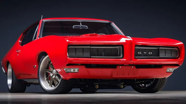 A low front shot of a bright red, rare 1968 Pontiac GTO show car with a hardtop.