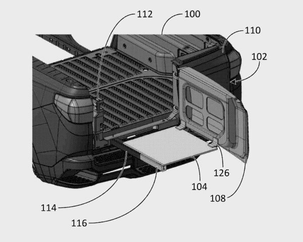 Pickup truck bed with tailgate open and a sliding tray extended from the bed.