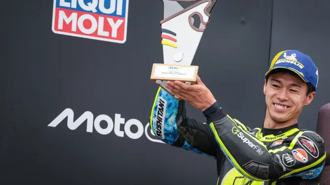 Pembalap MotoGP Jepang dari SuperFile Trackhouse Team, Ai Ogura, yang meraih posisi kedua, merayakan kemenangannya di podium setelah balapan Grand Prix MotoGP Jerman, di Hohenstein-Ernstthal dekat Chemnitz, Jerman timur pada 12 Juli 2026. (Ronny HARTMANN/AFP)