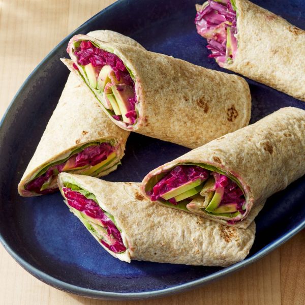 Overhead view of a blue plate of Anti-Inflammatory Beet & Avocado Wrap recipe ready to serve Credit: Photographer: Fred Hardy, Food Stylist: Jennifer Wendorf, Prop Stylist: Shell Royster