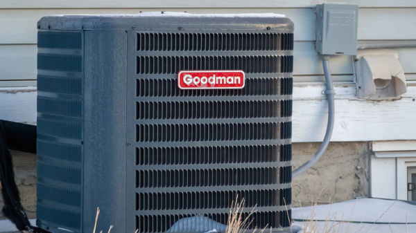A Goodman air conditioning unit outdoors.