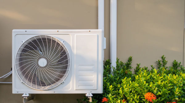 Outdoor air conditioner unit receiving sunlight.