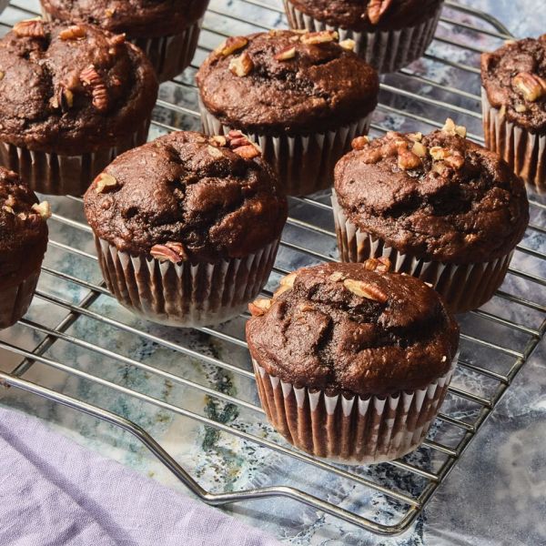 A recipe image as High-Protein Chocolate Banana Muffins. Credit: Photographer: Fred Hardy II., Prop Stylist: Josh Hoggle, Food Stylist: Chelsea Zimmer.