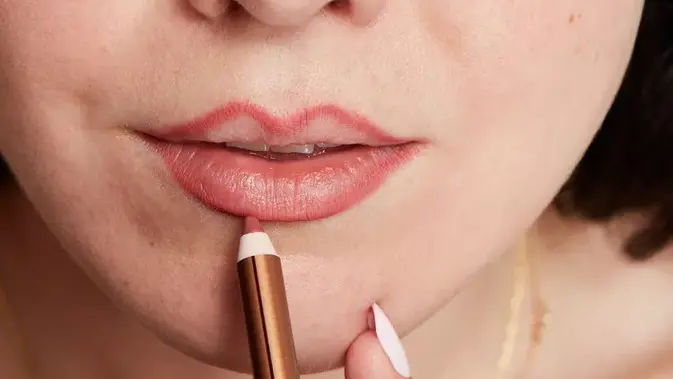 Gunakan lip liner dengan mengikuti bentuk alami bibir (copyright Byrdie/Dee Mills)