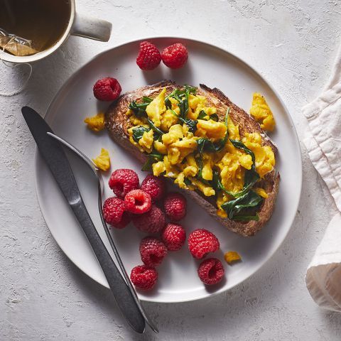 a photo of a plated Spinach & Egg Scramble with Raspberries Credit: Jen Causey