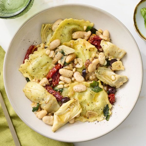 Bowl of Spinach Ravioli with Artichokes & Olives overhead Credit: Jacob Fox, Prop Stylist: Gabriel Greco, Food Stylist: Sammy Mila