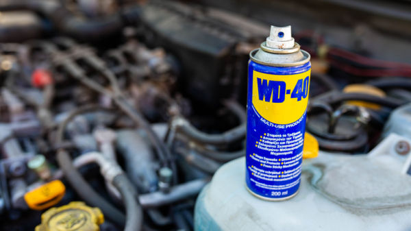WD40 can next to car engine