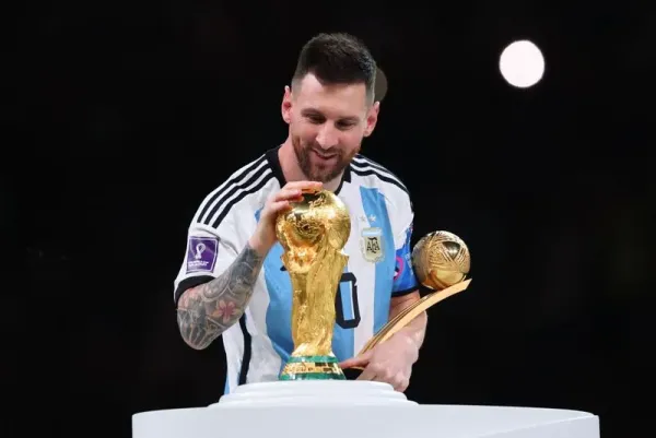 LUSAIL CITY, QATAR - DECEMBER 18: Lionel Messi of Argentina celebrates with the World Cup Trophy and player of the tournament award during the FIFA World Cup Qatar 2022 Final match between Argentina and France at Lusail Stadium on December 18, 2022 in Lusail City, Qatar. (Photo by Marc Atkins/Getty Images)