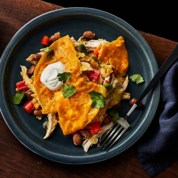 a recipe photo of the Slow-Cooker Chicken & Pinto Bean Enchilada Casserole served on a plate Credit: Photographer: Greg DuPree, Food Stylist: Ali Ramee Prop Stylist: Christine Keely
