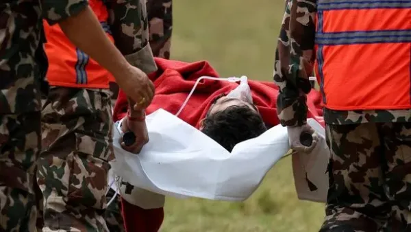 Survivor Sanjay Sah is carried by members of a search and rescue team after they rescued alive two people who had been trapped inside a tunnel at the Upper Trishuli-3A Hydropower Project following devastating floods and mudslides that struck the Bhotekoshi River in Rasuwa, Nepal, September 4, 2026. Nepal Army/Handout via REUTERS. THIS IMAGE HAS BEEN SUPPLIED BY A THIRD PARTY. MANDATORY CREDIT. NO RESALES. NO ARCHIVES.  REFILE - ADDING THE NAME OF THE SURVIVOR