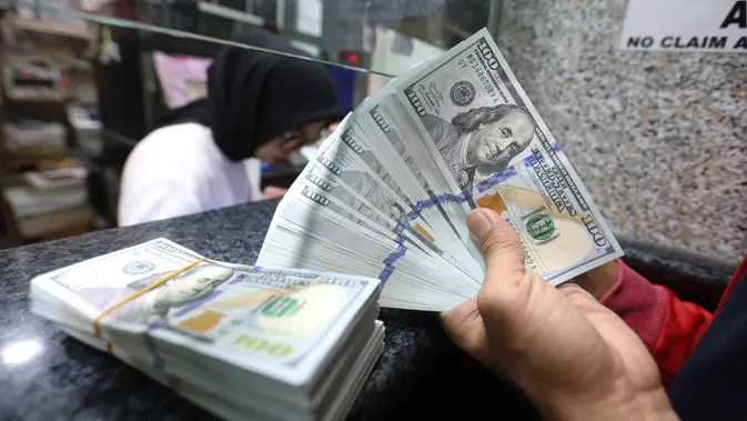 Karyawan menunjukkan uang pecahan dolar Amerika Serikat (AS) di salah satu gerai penukaran mata uang asing, Jakarta. (Kapanlagi.com/Budy Santoso)